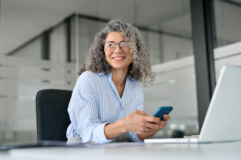 midlife woman sits at desk