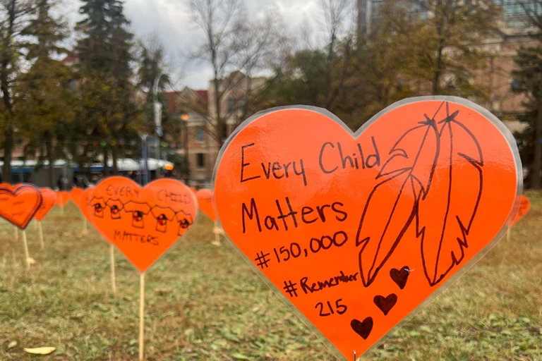 Orange heart sign with 'every child matters' and #Remember215 in the ground