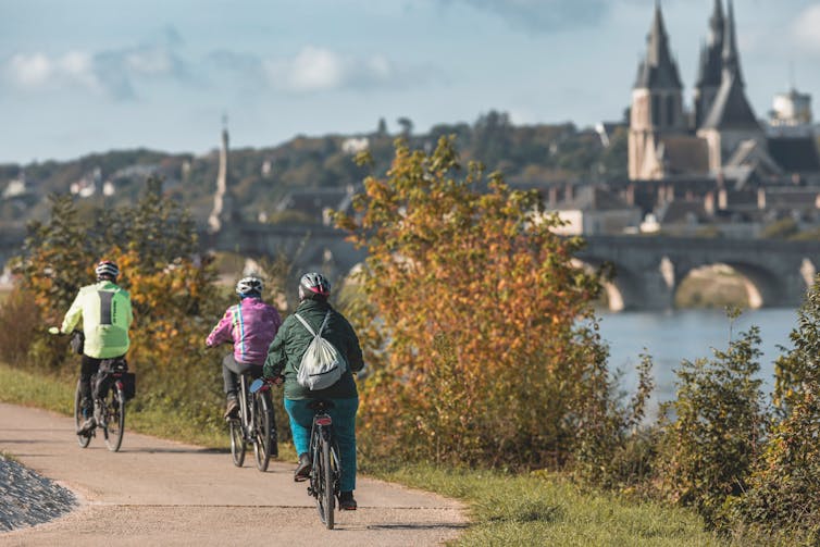 three people riding bikes to town
