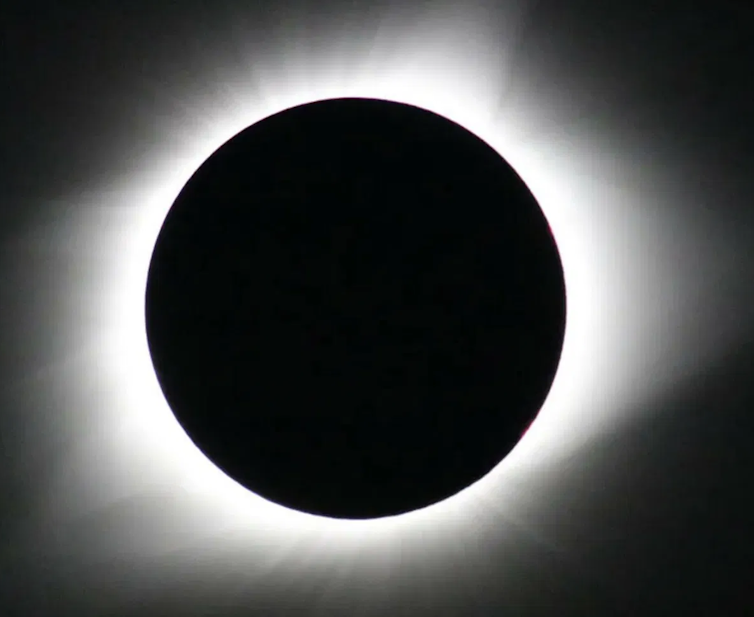 An image of a Total eclipse showing the Corona of the Sun.
