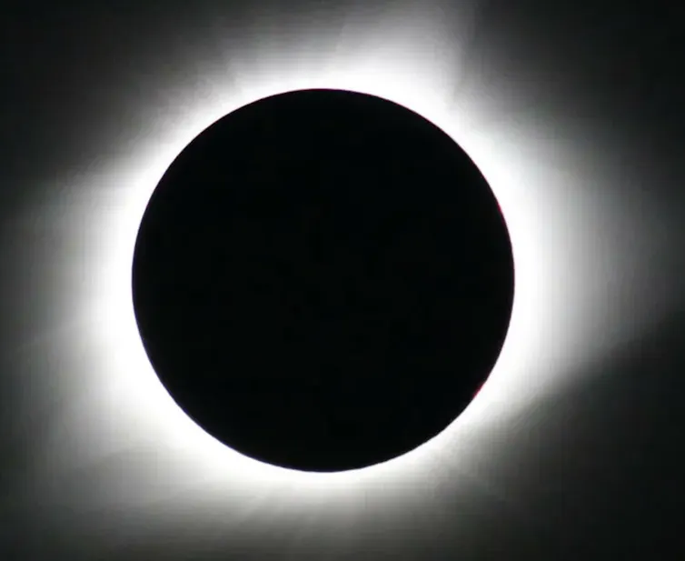 An image of a Total eclipse showing the Corona of the Sun.