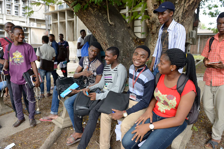 A group of people sitting under a tree