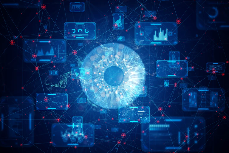 An electric blue eye is at the center of a network of computer data against a dark background.