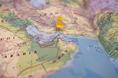 Section of a world map with a pin in it