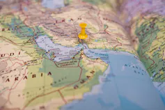 Section of a world map with a pin in it