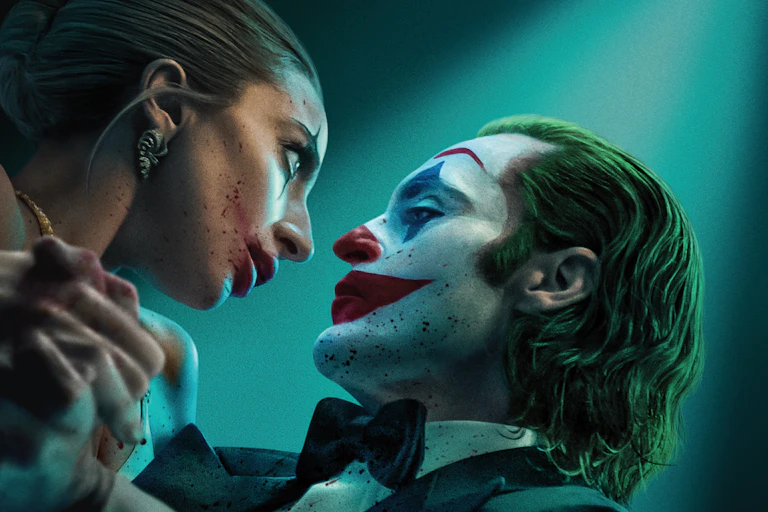 man and woman stare at each other while dancing. both have clown face paint