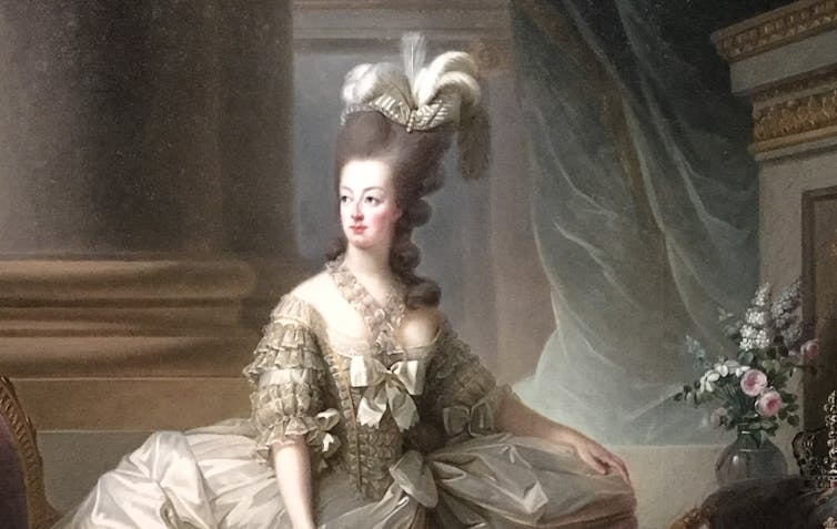 Painted portrait of Marie Antoinette with elaborate grey hairstyle.
