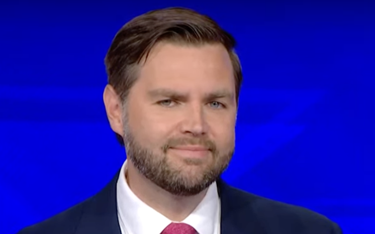 Bearded man with a tight grin.