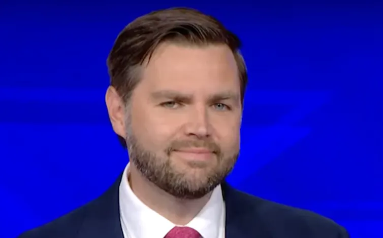 Bearded man with a tight grin.