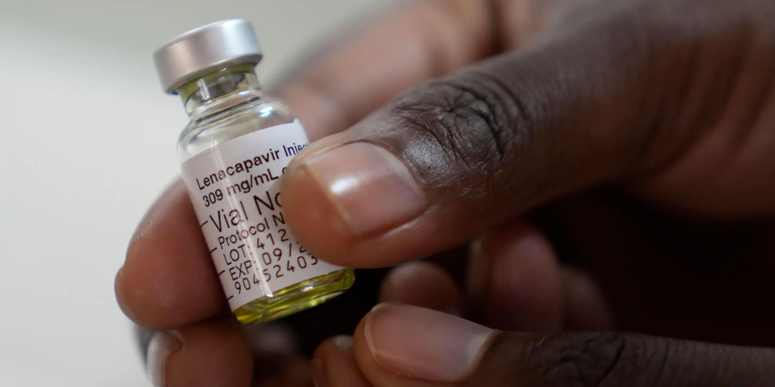 A clinician holds a vial of a drug called lenacapavir