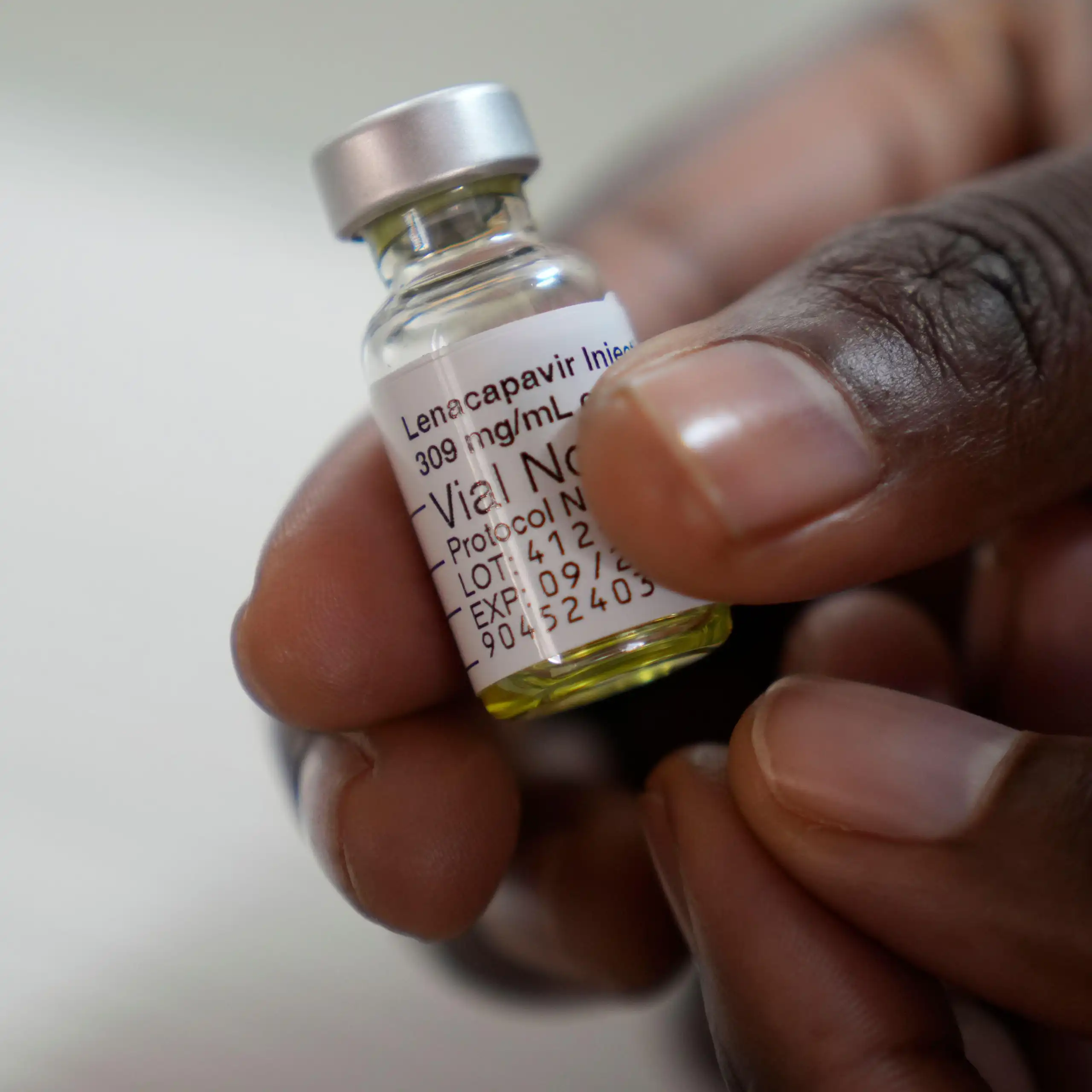 A clinician holds a vial of a drug called lenacapavir