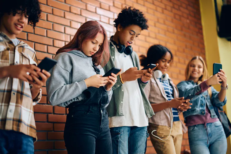 Teenagers looking at their phones
