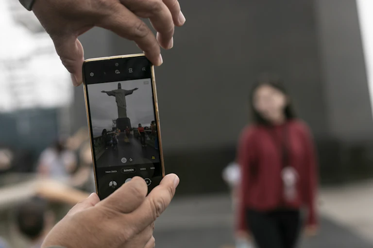 Christ the Redeemer being photographed from a mobile phone
