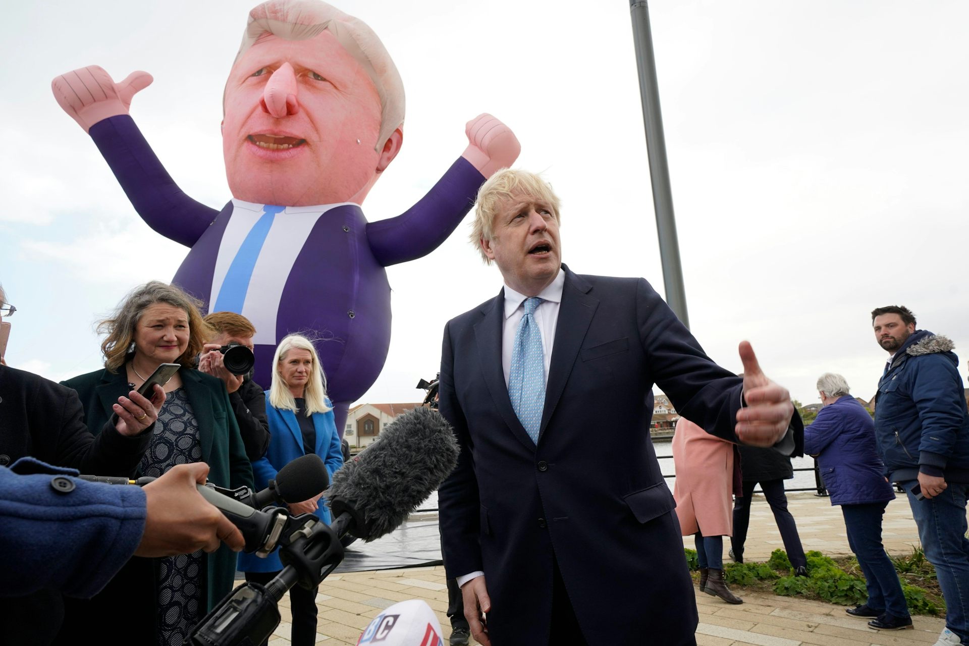 Boris Johnson stands in front of a blow-up version of himself. 