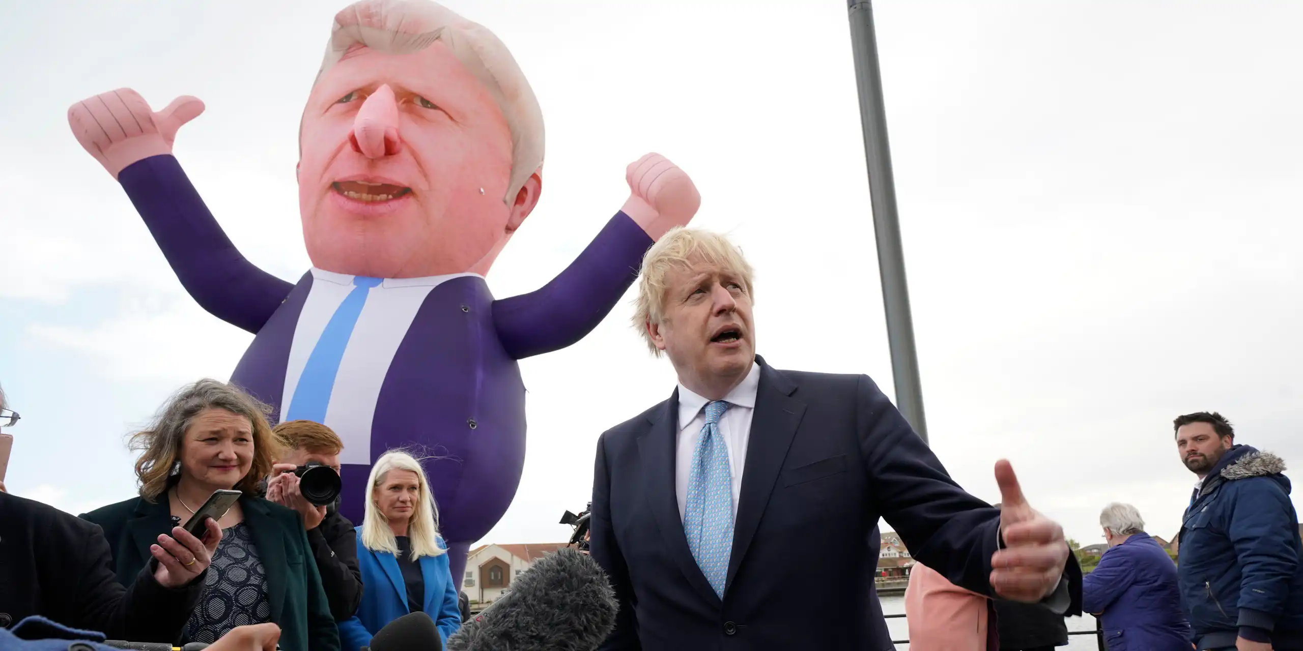 Boris Johnson stands in front of a blow-up version of himself.