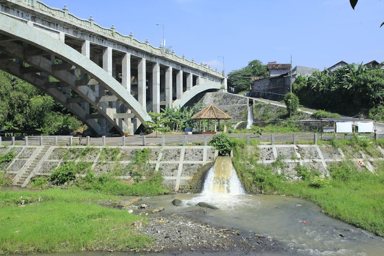 Water from a drainage system enters a creek in Yogyakarta, Indonesia.