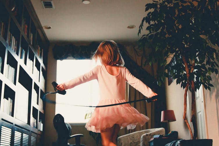 Girl in tutu holds skipping rope