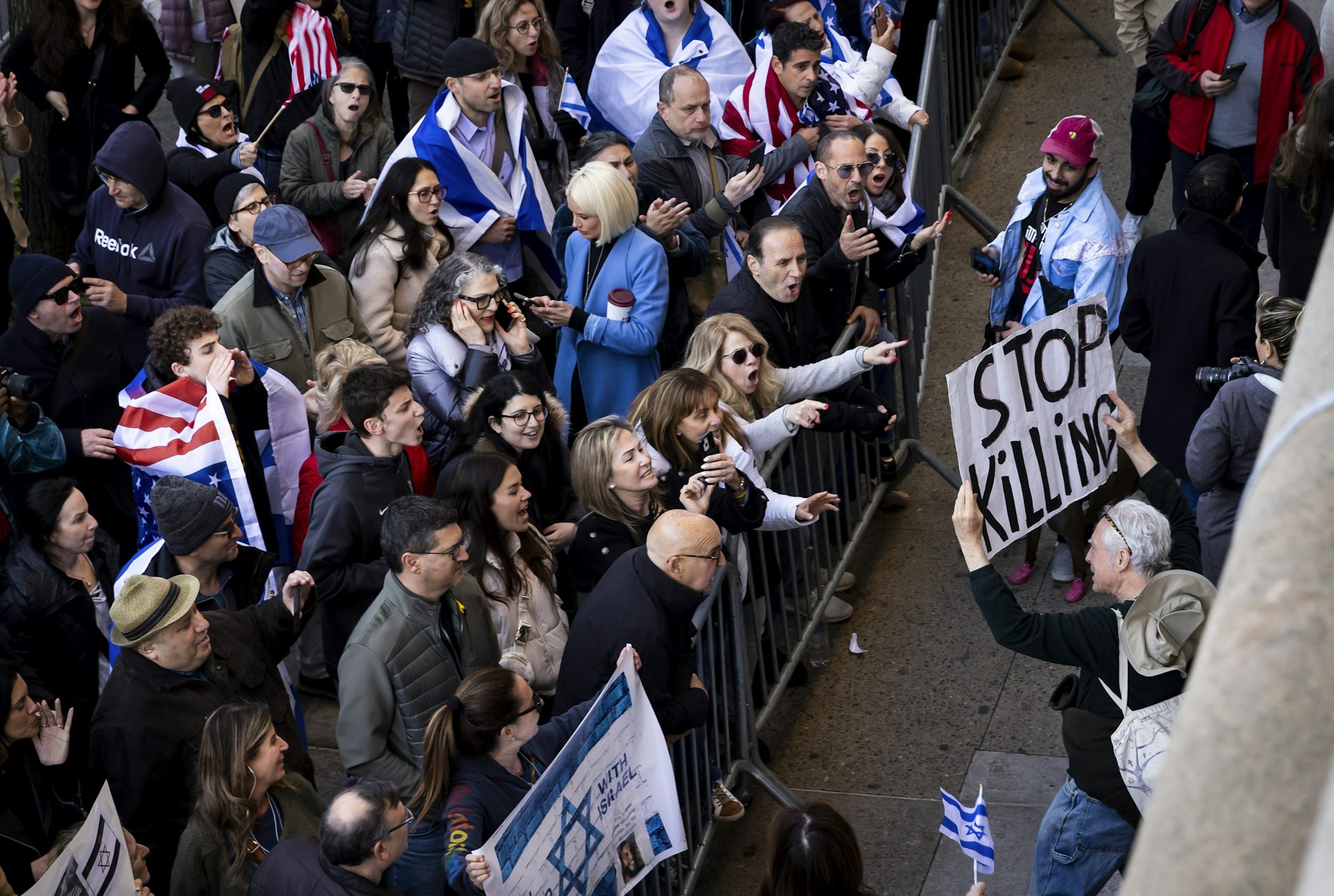 Two groups of protestors shouting at each other.