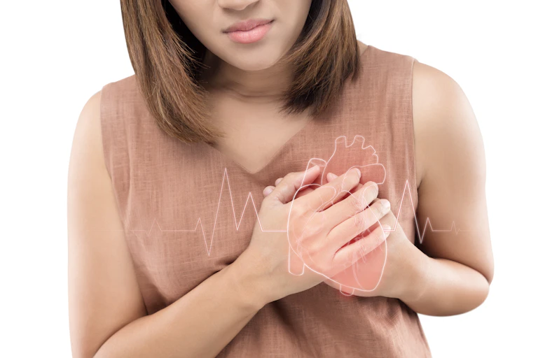A woman experiencing a heart attack holds her chest in pain.