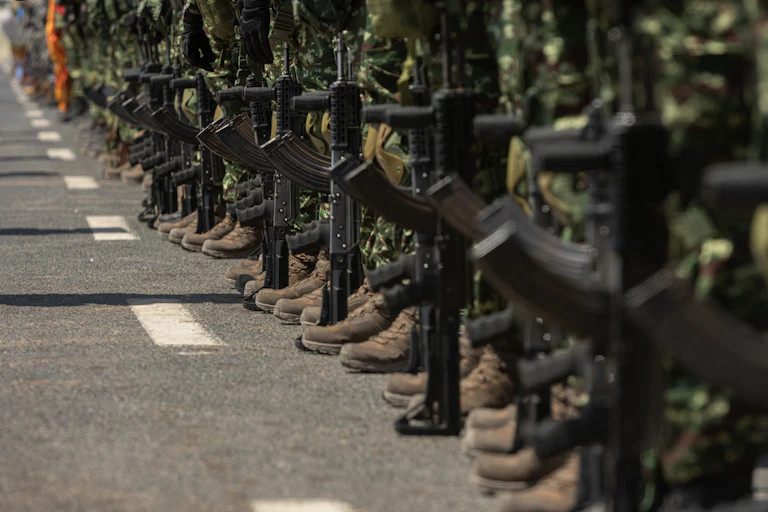 A line of soldiers standing with rifles, with their faces out of the shot