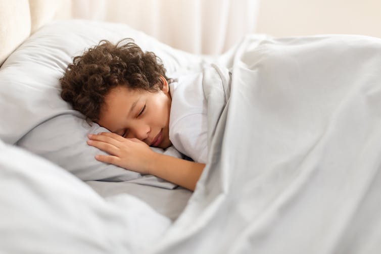 A boy sleeping in bed
