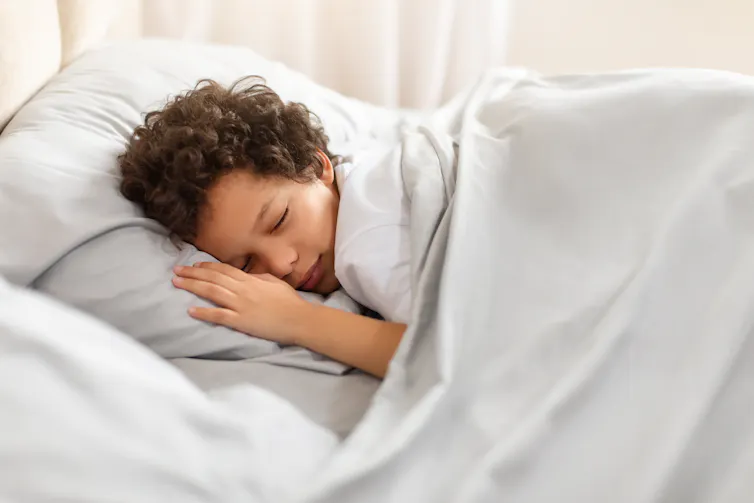 A boy sleeping in bed