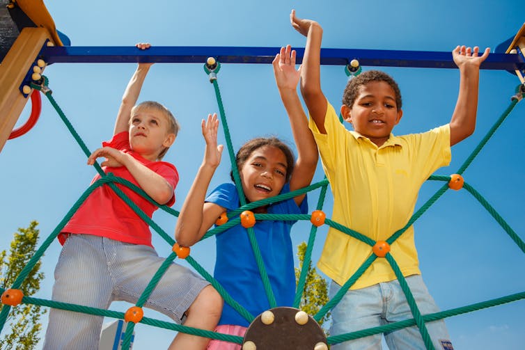 Three children on a climbing net