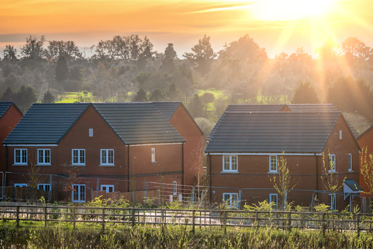 Sunshine behind new housing development.