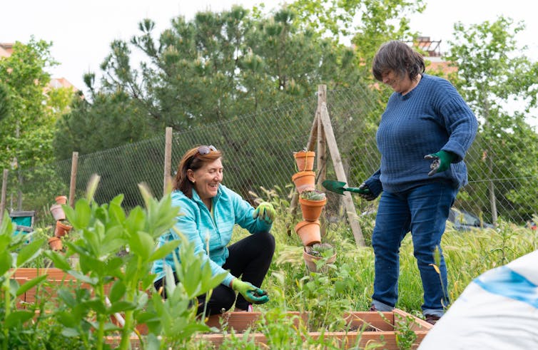 Two women working in a community garden