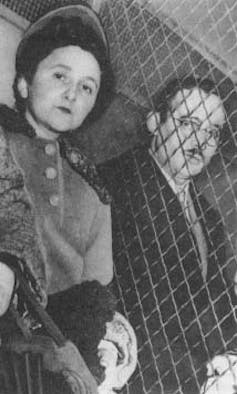 Ethel and Julius stand side by side, separated by a wire fence