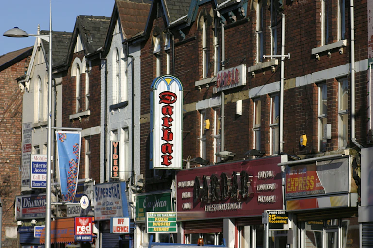 A row of terraced homes above shops and restaurants.