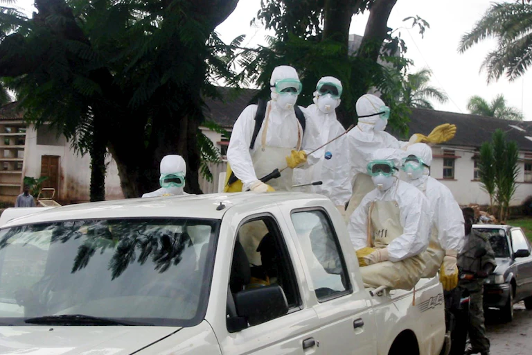 People on the way to clean a hospital beset by Marburg virus during the 2005 outbreak in Anglola.