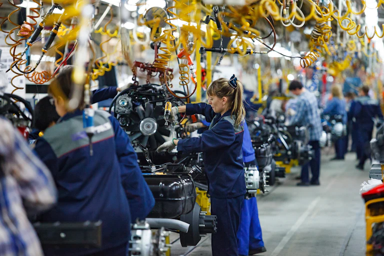 Men and women working on a production line