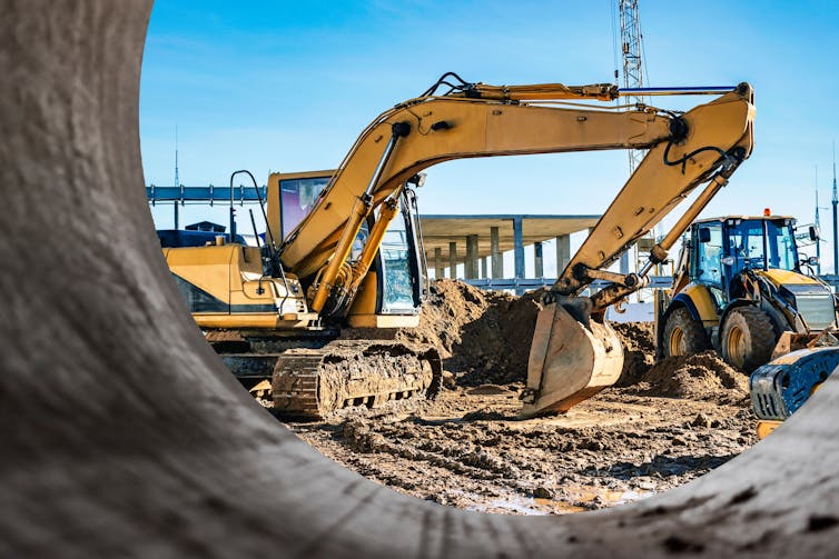 Yellow crawler excavator at the construction site.