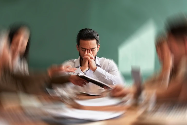 Stressed-out man in a meeting