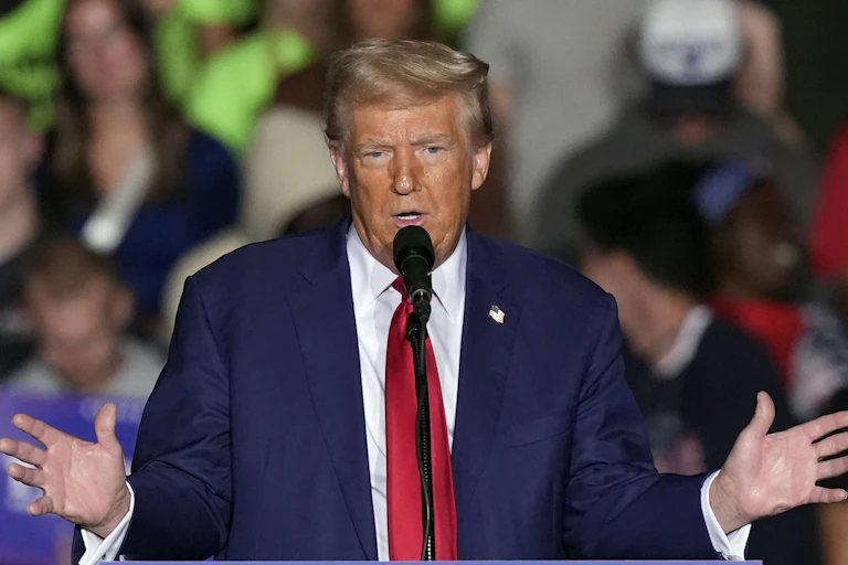 A man speaks at a lectern.