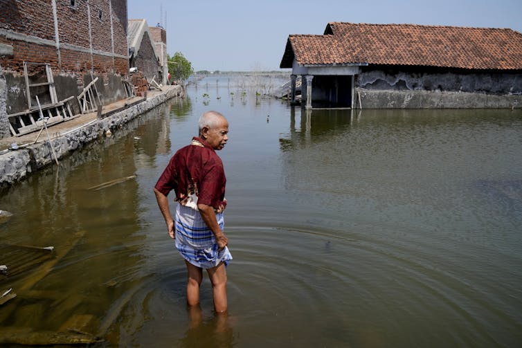 man standing flooded field