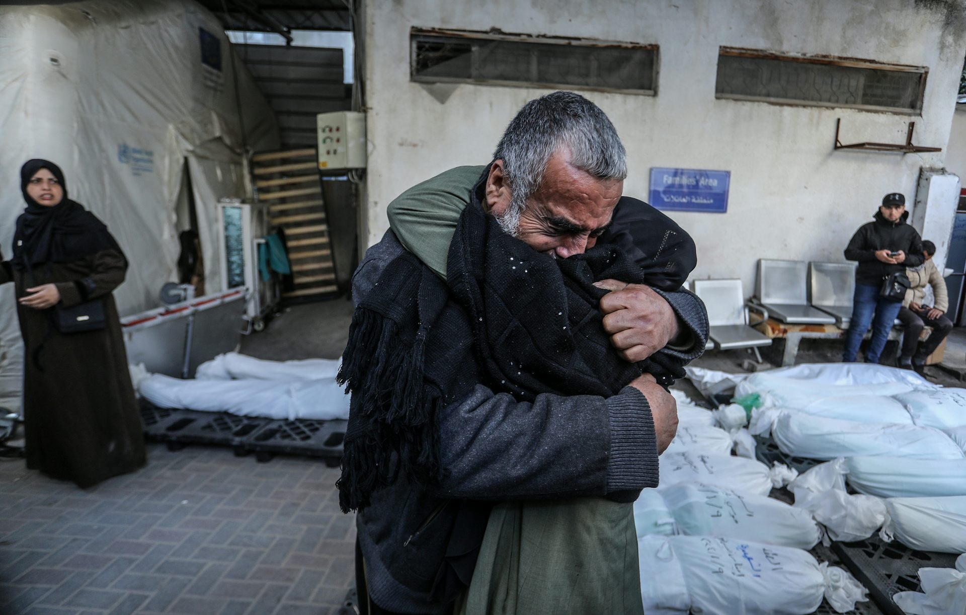 Two people hugging on the street.