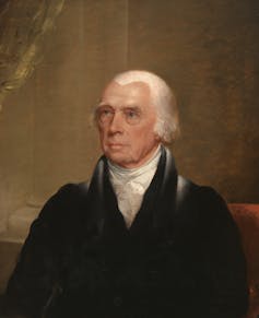A man in formal dress and a colonial hairstyle.