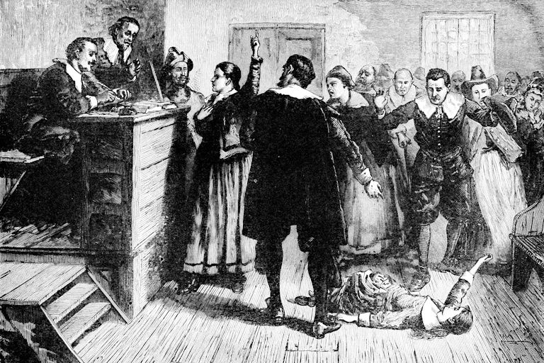 A black and white illustration showing several people gathered around a man seated at a tall desk. Ahead of him, a woman is lying on the ground and several others are pointing a finger at her.
