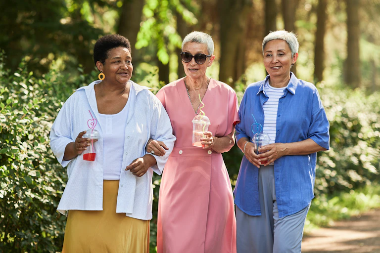 Three older women walking outdoors