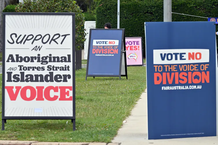 Vote No and Vote Yes signs on footpath.