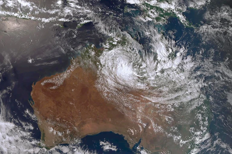 Satellite photo of Australia showing a large swirl of cloud over the north.