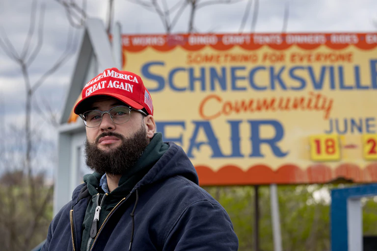 A Donald Trump supporter wearing a cap with "Make America Great Again" on it.