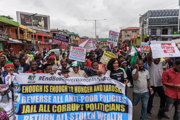 People carrying placards and banners while demonstrating on the street