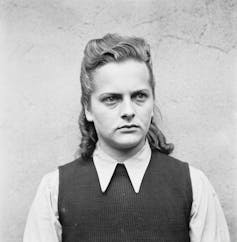 A black and white image of a young German woman looking stern.