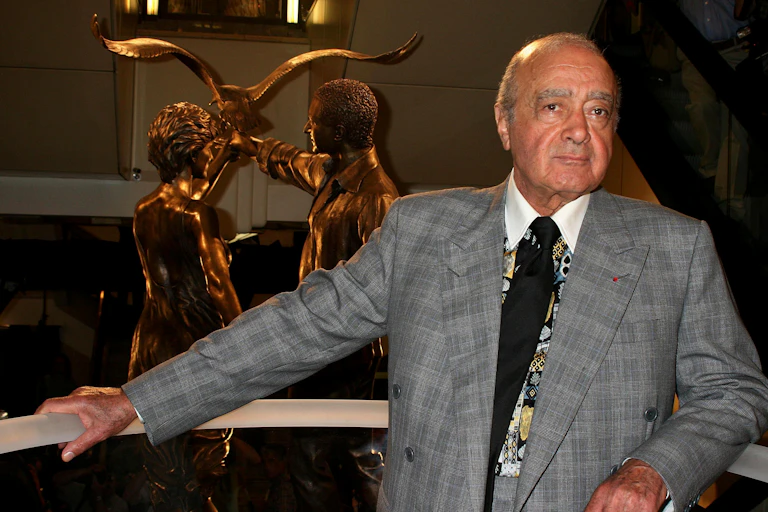Mohamed Al Fayed posing with golden statue of princess Diana and his son Dodi