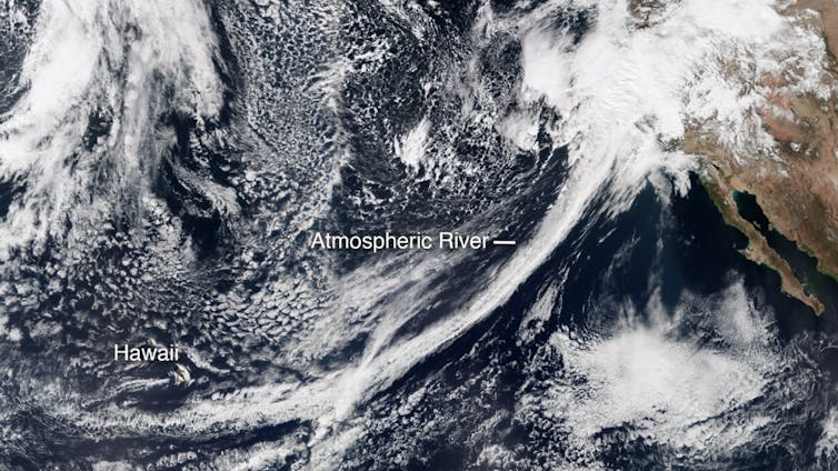 A long narrow band of moisture sweeps up toward California, crossing hundreds of miles of Pacific Ocean.