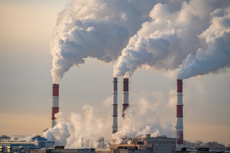 Four smokestacks at a power plant.