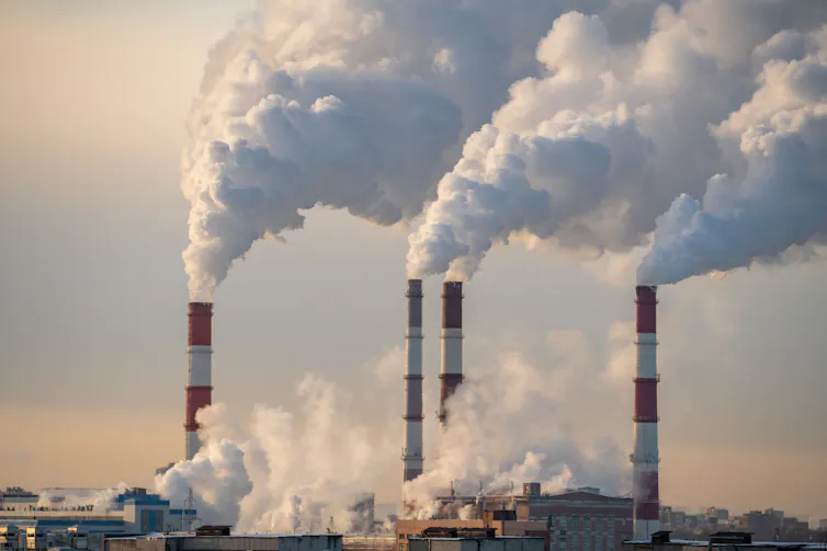Four smokestacks at a power plant.